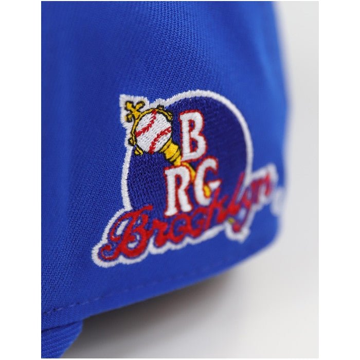 Brooklyn Royal Giants Legacy Baseball Cap (Side Detail) - Blue cap with embroidered logo featuring a baseball and text on a white background