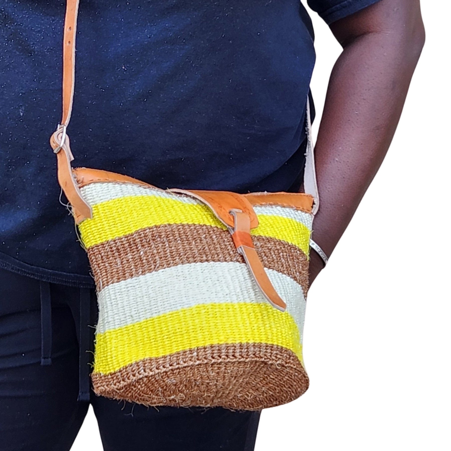 11 of 12: Nanyori: Authentic Hand Woven Sisal and Leather Kenyan Kiondo (Lifestyle View 2 - Brown, Yellow and Natural Colors)