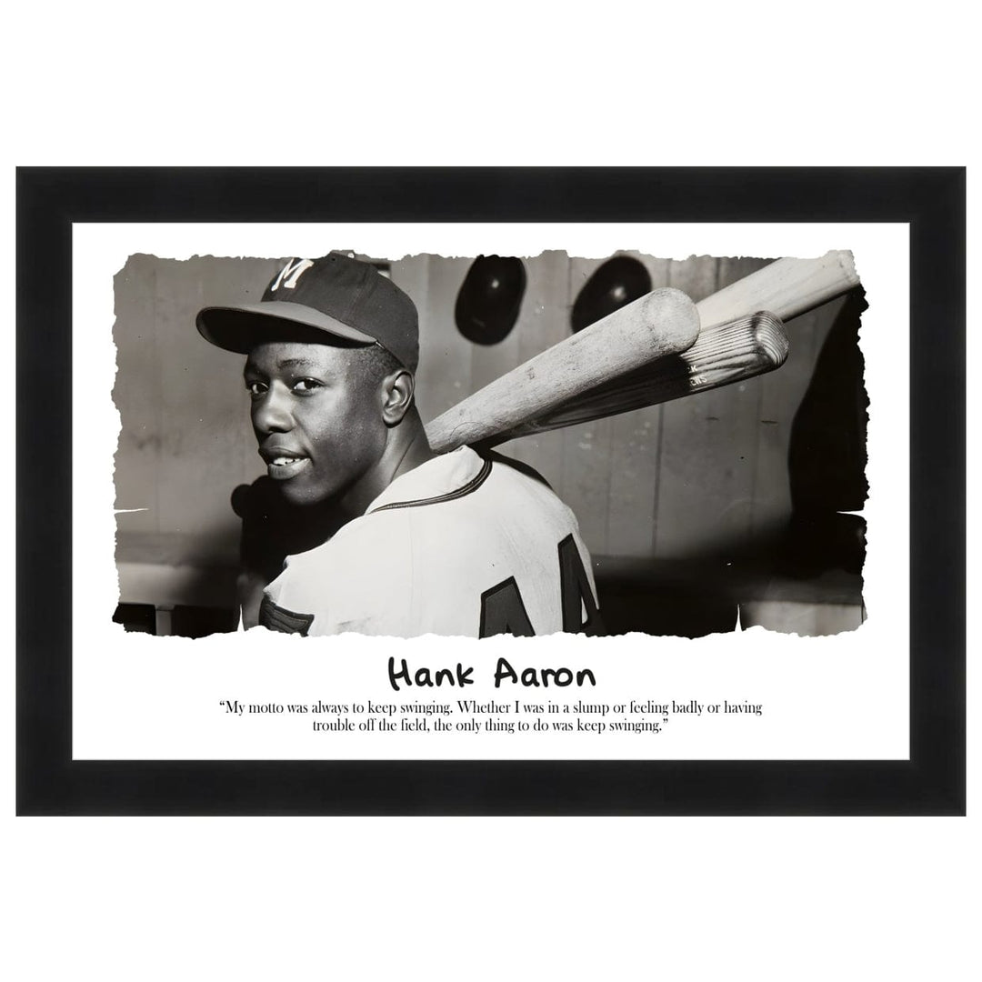 Hank Aaron: Keep Swingin' by Sankofa Designs - Black and white photo of Hank Aaron with bats, featuring a quote about maintaining determination. (Black Frame)