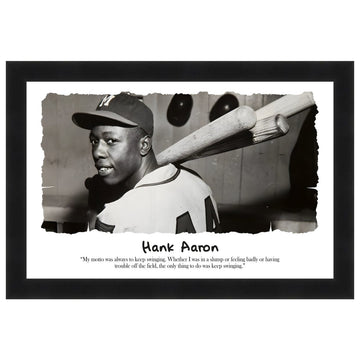Hank Aaron: Keep Swingin' by Sankofa Designs - Black and white photo of Hank Aaron with bats, featuring a quote about maintaining determination. (Black Frame)