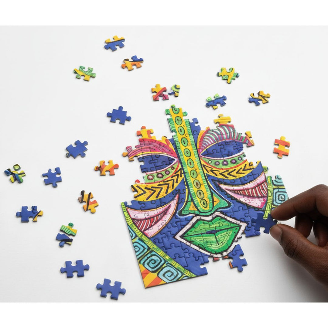 Inspire by Sylvia "Gbaby" Cohen: African American Jigsaw Puzzle (Mockup) - Colorful puzzle with a hand completing a piece on a white background