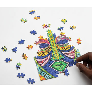 Inspire by Sylvia "Gbaby" Cohen: African American Jigsaw Puzzle (Mockup) - Colorful puzzle with a hand completing a piece on a white background