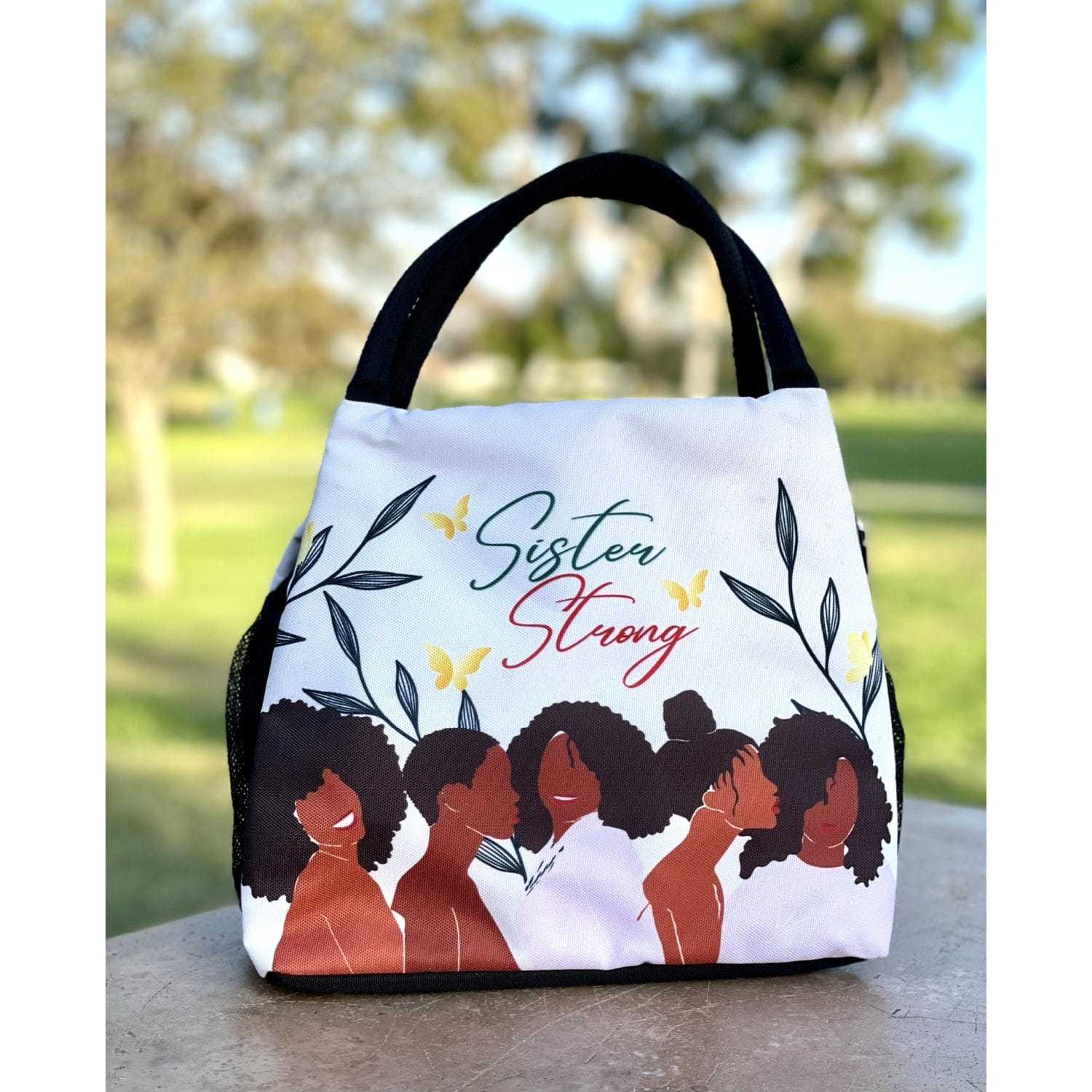 5 of 6: Janine Kai Robinson's Sister Strong lunch bag featuring Black women silhouettes (lifestyle 3)