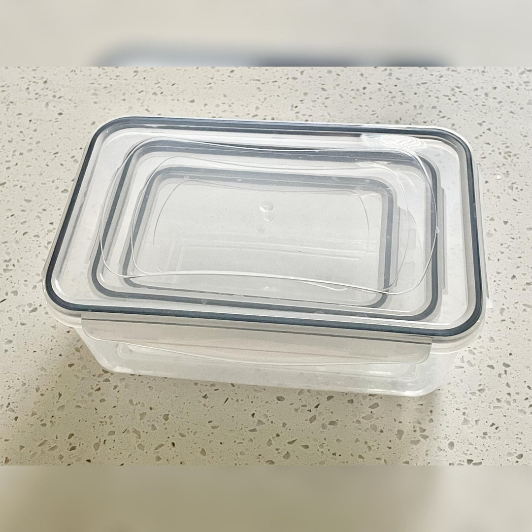 Live Life on Purpose Insulated Lunch Bag Set with Food Containers - Stack of clear plastic containers with black lids on a speckled countertop