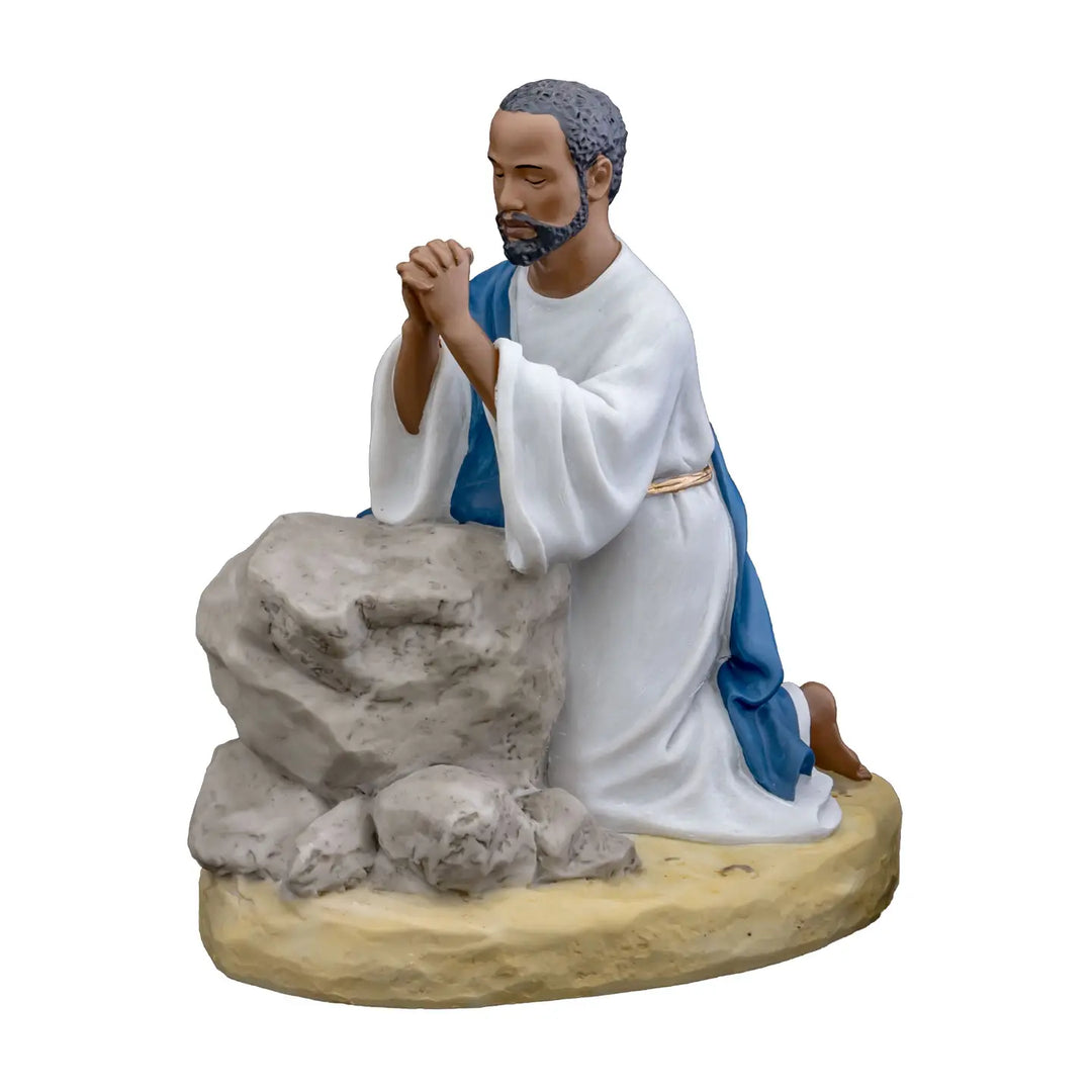 African American Jesus Praying in the Garden Figurine (Main) - Statue of a man in a white robe and blue cloak kneeling by a rock formation on a white background