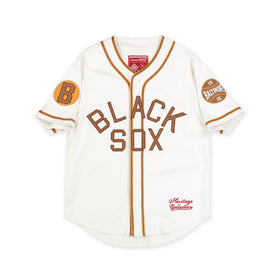 Baltimore Black Sox Negro Leagues Heritage Baseball Jersey (Main) - A vintage-style Baltimore Orioles baseball jersey in off-white with brown lettering and trim, featuring 'BLACK SOX' across the front, a 'B' patch on the right sleeve, and a 'BALTIMORE 1919' patch on the left sleeve.