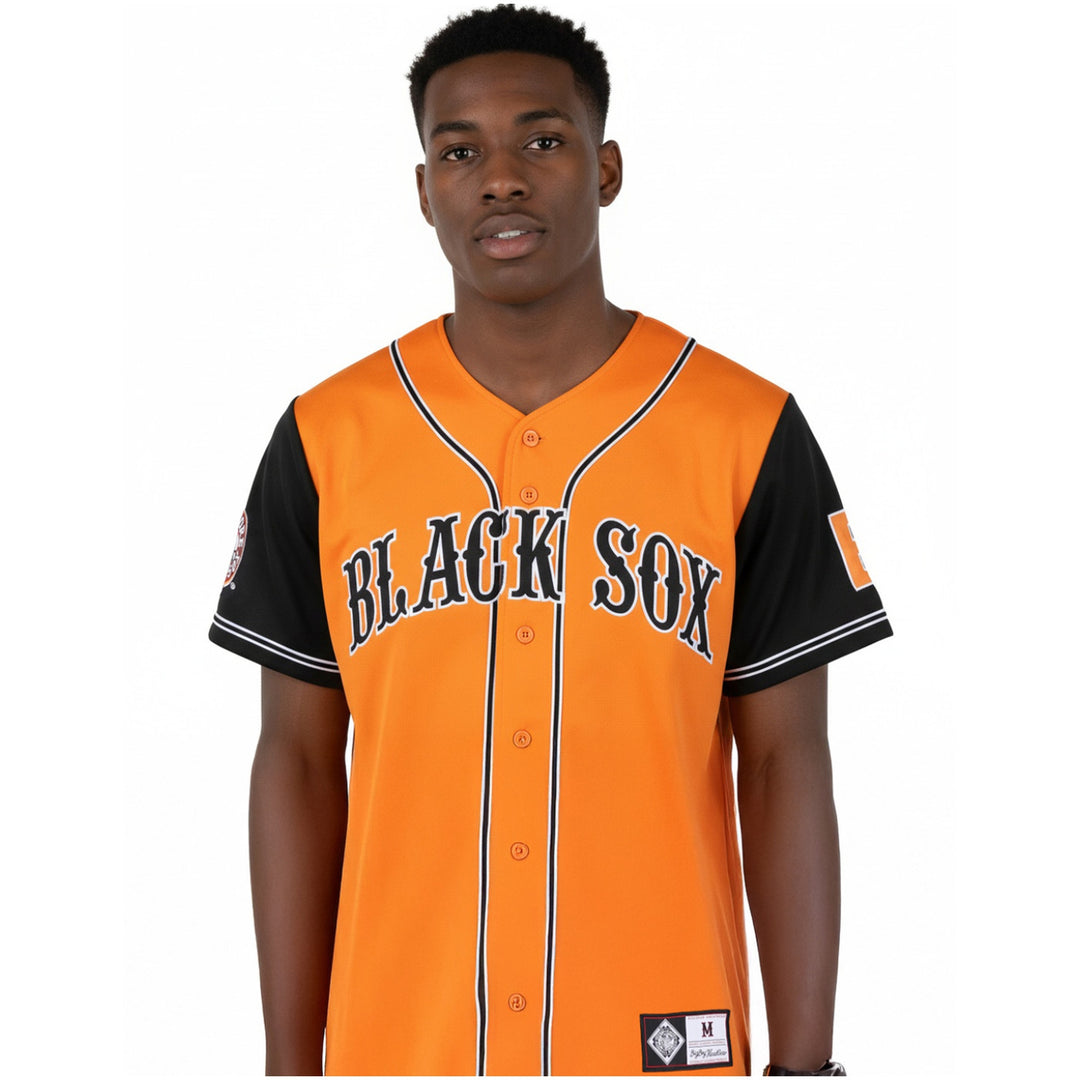 Baltimore Black Sox Legacy Baseball Jersey (Lifestyle) - A man wearing an orange and black Boston Red Sox baseball jersey with 'BLACK SOX' printed across the chest, shown against a plain white background.