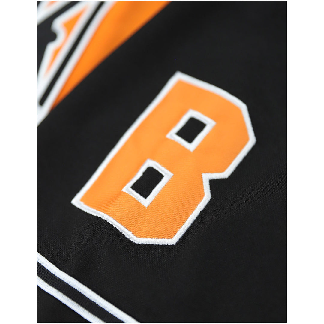 Baltimore Black Sox Legacy Baseball Jersey (Sleeve Detail) - Close-up of a black athletic jersey with a large orange letter B outlined in white on the back.