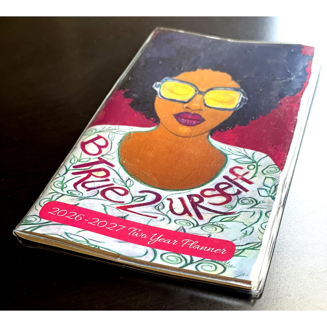 Be True to Yourself: 2026-2027 Two Year Black Art Pocket Planner (Lifestyle Photo 2) - Planner with a colorful cover featuring a person with sunglasses and text 'Be True to Yourself'.