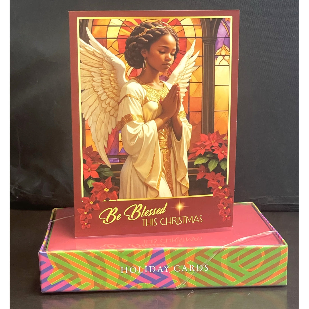 Blessings Upon Blessings (Angel): Afrocentric Christmas Card Box Set (Full Box) - Holiday card with an angel design and 'Be Blessed This Christmas' text, displayed in front of a matching box.