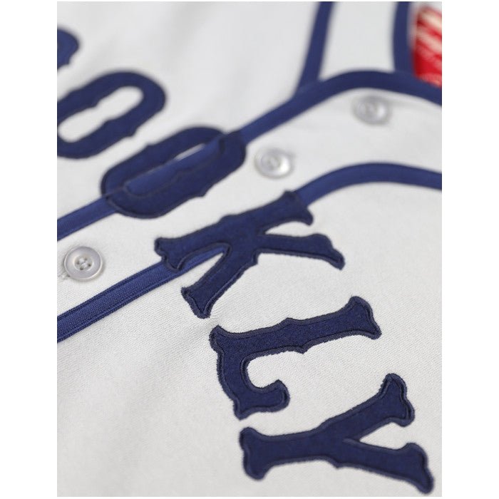 Brooklyn Eagles Heritage Negro League Baseball Jersey - Close-up of a baseball jersey with 'Brooklyn' text in  blue on a gray background. (Front, Detail)