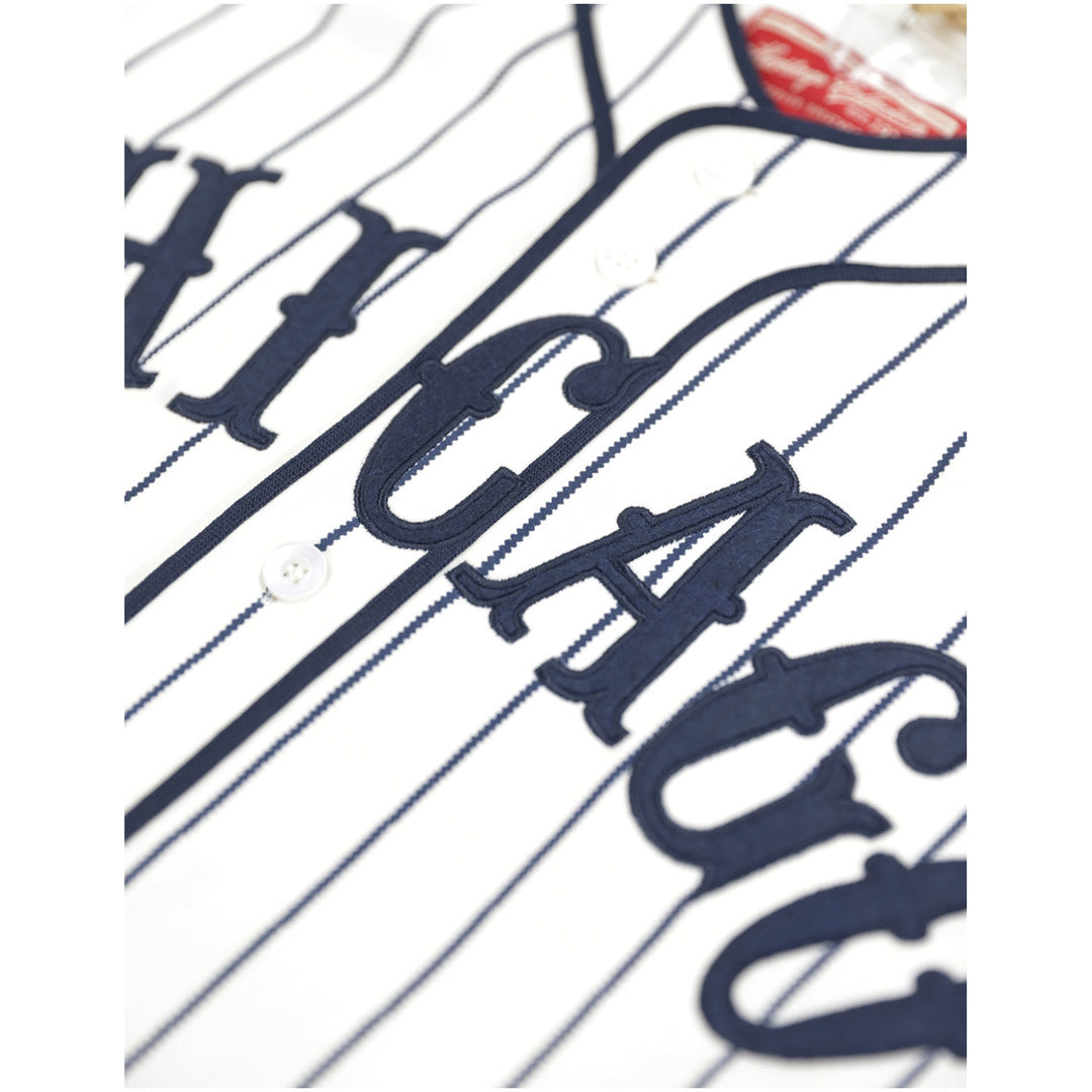 Chicago American Giants Heritage Negro Leagues Baseball Jersey (Front Detail) - Close-up of a white pinstriped baseball jersey with navy blue varsity-style lettering and a white button.