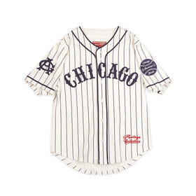 Chicago American Giants Heritage Negro Leagues Baseball Jersey (Main) - A vintage-style Chicago baseball jersey with vertical navy pinstripes on an off-white base. It features 'CHICAGO' arched across the chest in navy, a navy 'C' logo on the right sleeve, a baseball patch on the left sleeve, and 'Heritage Athletics' in red script near the lower left hem.