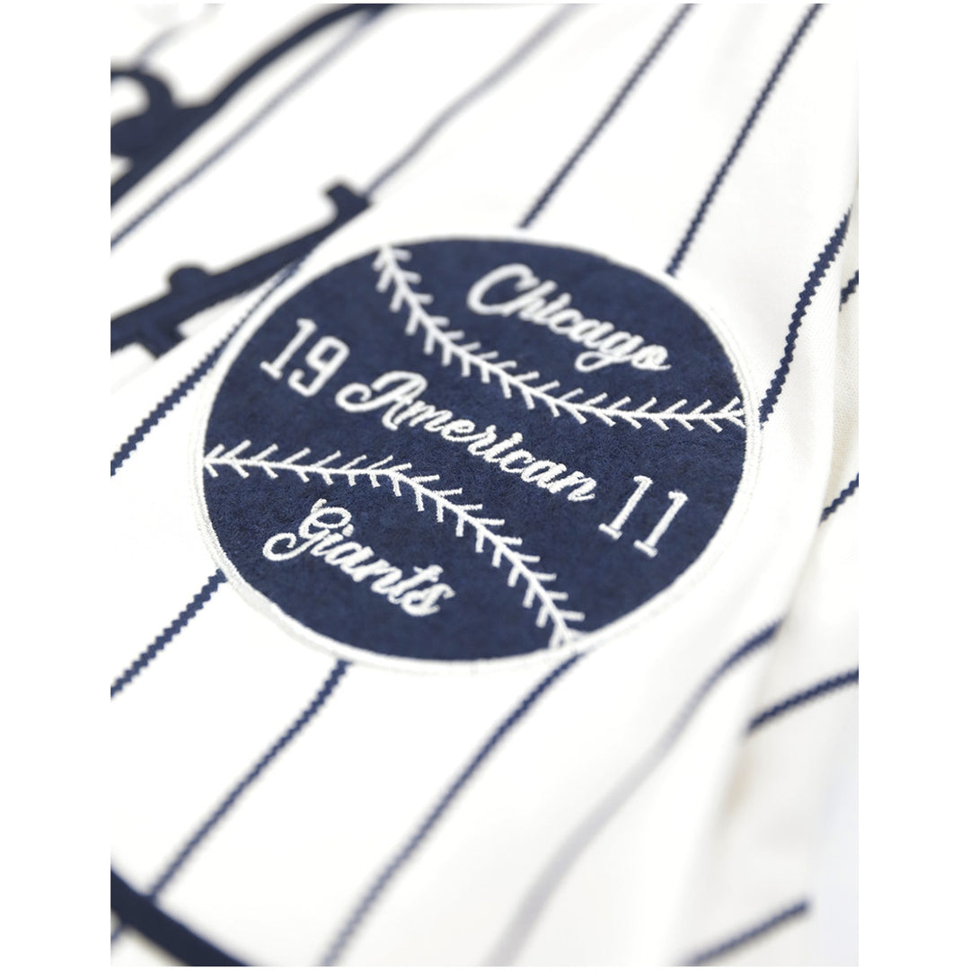 Chicago American Giants Heritage Negro Leagues Baseball Jersey (Sleeve Detail 2) - A close-up of a navy blue circular baseball patch with white embroidered text reading 'Chicago 19 American 11 Giants' on a white pinstriped fabric background.