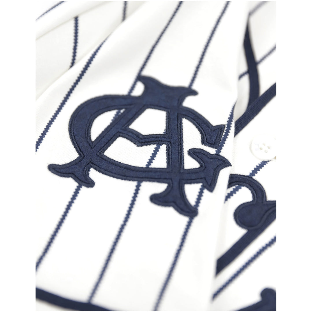 Chicago American Giants Heritage Negro Leagues Baseball Jersey (Sleeve Detail) - Close-up of a white pinstriped baseball jacket or shirt with a large navy embroidered monogram logo on the chest.
