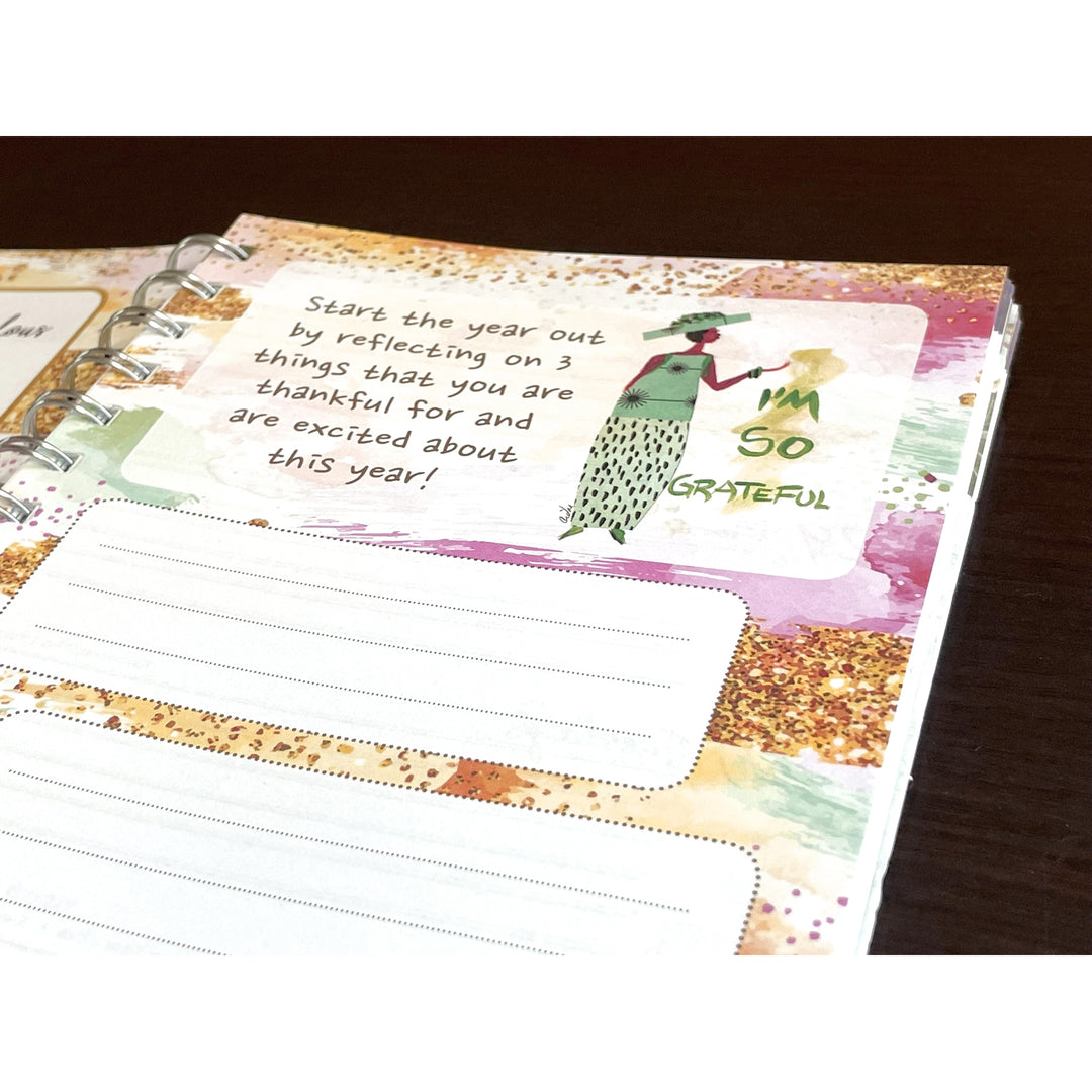 Can't Keep a Good Sistah Down by Cidne Wallace: 2026 African American Weekly Inspirational Planner (Journaling Page) - Notebook with gratitude reflection page on a wooden surface