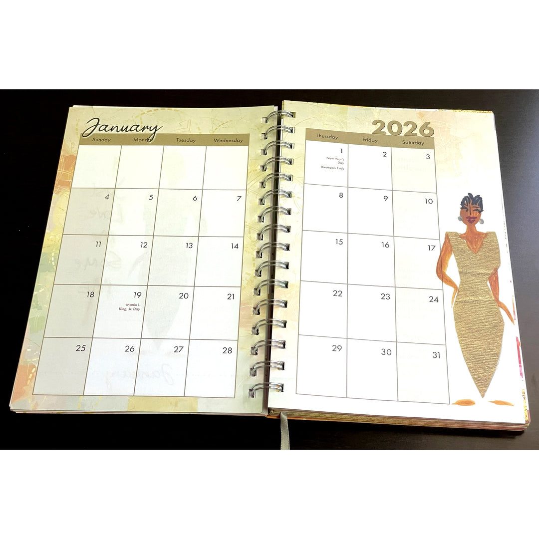 Favor and Glory by Cidne Wallace: 2026 Weekly Inspirational Planner (Monthly View) - Open spiral-bound calendar showing January and a woman in a dress on a black background