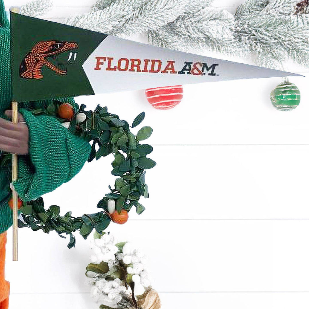 Florida A&M Rattlers pennant and orange berry wreath held by FAMU Proud Santa