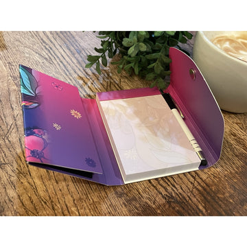 Garden Spirit: African American Stylus Purse Pal by Pamela Hills (Interior) - Open notebook with floral design on a wooden surface next to a cup of coffee and plant