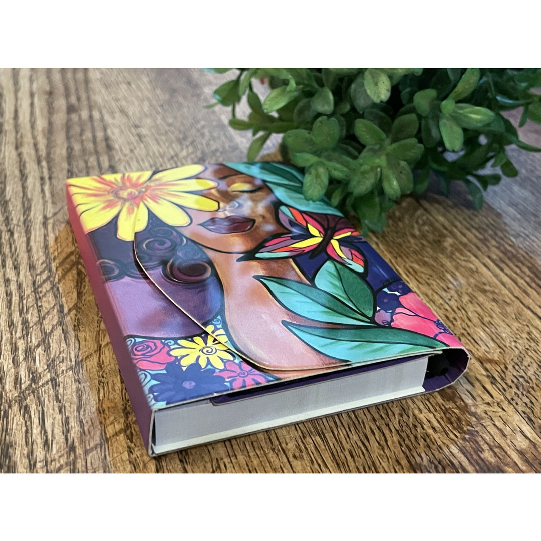 Garden Spirit: African American Stylus Purse Pal by Pamela Hills (Lifestyle) - Colorful notebook with floral design on a wooden surface