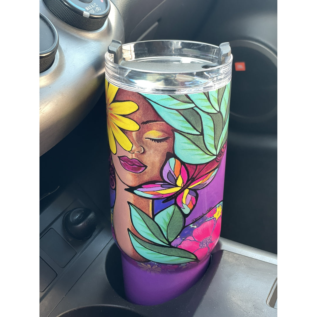 Garden Spirity by Pamela Hills: African American Tumbler with Long Handle (Llfestyle) - A purple insulated tumbler with a clear lid sits in a car cup holder. The tumbler is decorated with a colorful illustration of a woman's face, flowers, and leaves.