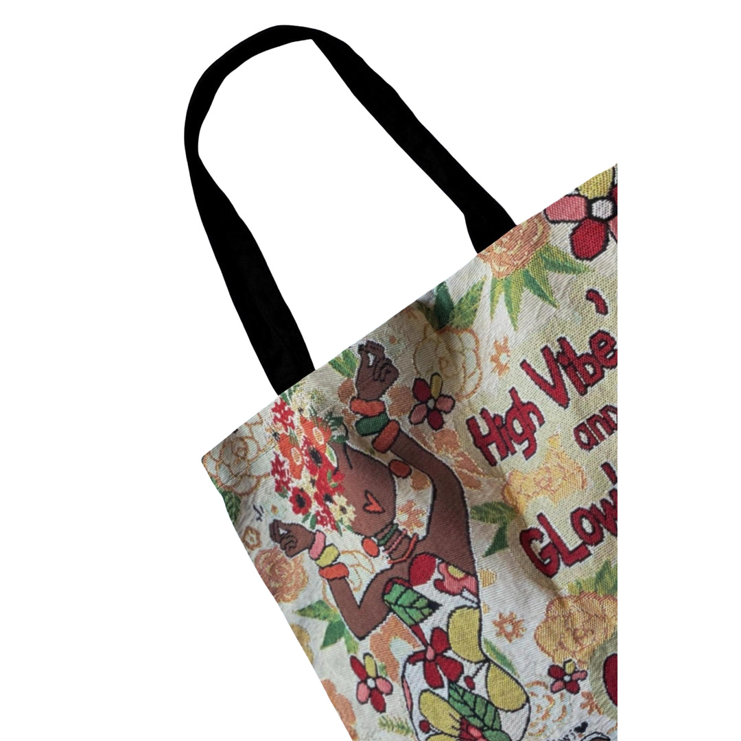 Glow'd Up by Kiwi McDowell: African American Woven Tote Bag (Detail) - Tote bag with floral design and text on a white background