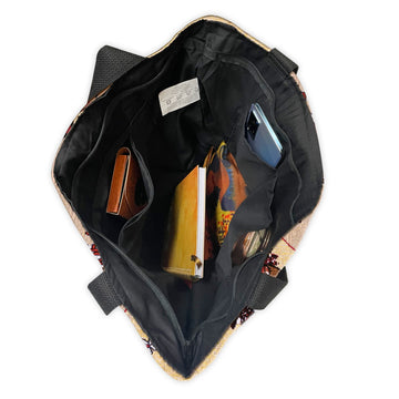 Glow'd Up by Kiwi McDowell: African American Woven Tote Bag (Interior) - Open backpack showing its compartments with a phone, wallet, and books inside.
