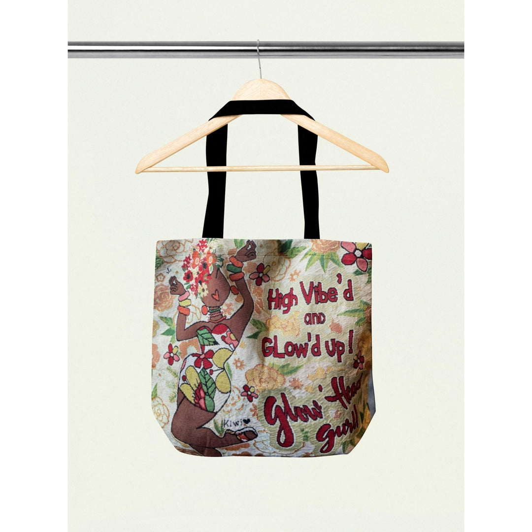 Glow'd Up by Kiwi McDowell: African American Woven Tote Bag (Storage) - Tote bag with floral design and text on a hanger against a white background