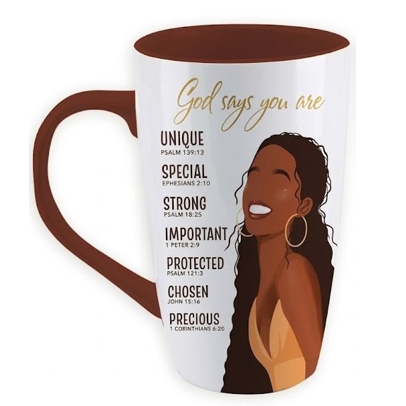 God Says You Are Ceramic Latte Mug (Front) - A white ceramic coffee mug with a dark brown handle and interior, featuring a gold cursive script that reads 'God says you are' above a list of affirmations and an illustration of a smiling Black woman with long braids and gold hoop earrings.