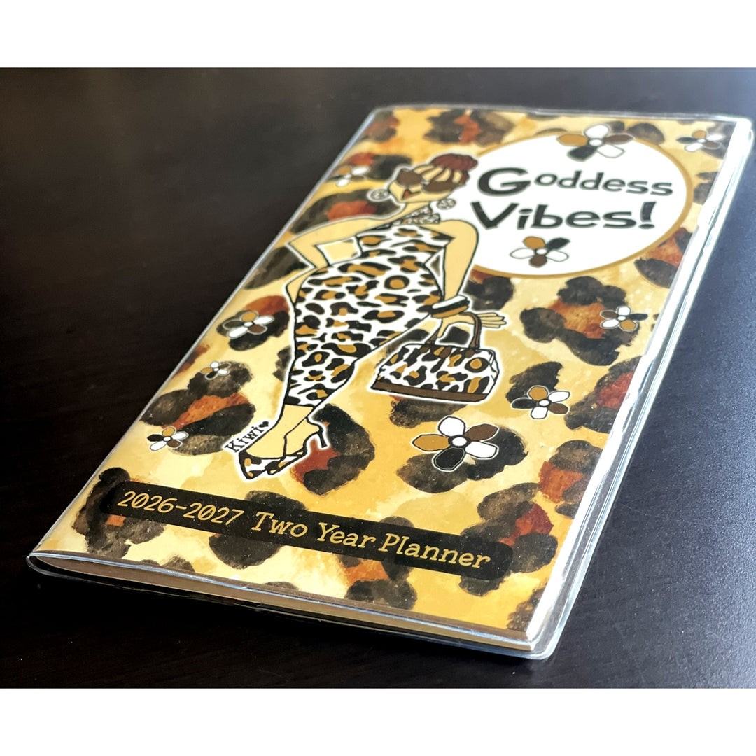 Goddess Vibes by Kiwi McDowell: 2026-2027 Two Year African American Pocket Calendar (Lifestyle Photos 2) - Two-year planner with leopard print design and 'Goddess Vibes!' text on a dark surface