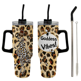 Goddess Vibes by Kiwi McDowell: African American Tumbler with Long Handle (Main) - Two views of a handled tumbler with a leopard print design, black handles and straws, and a clear lid. One view shows a fashion illustration of a woman, and the other shows a white circle with the text 'Goddess Vibes!'.
