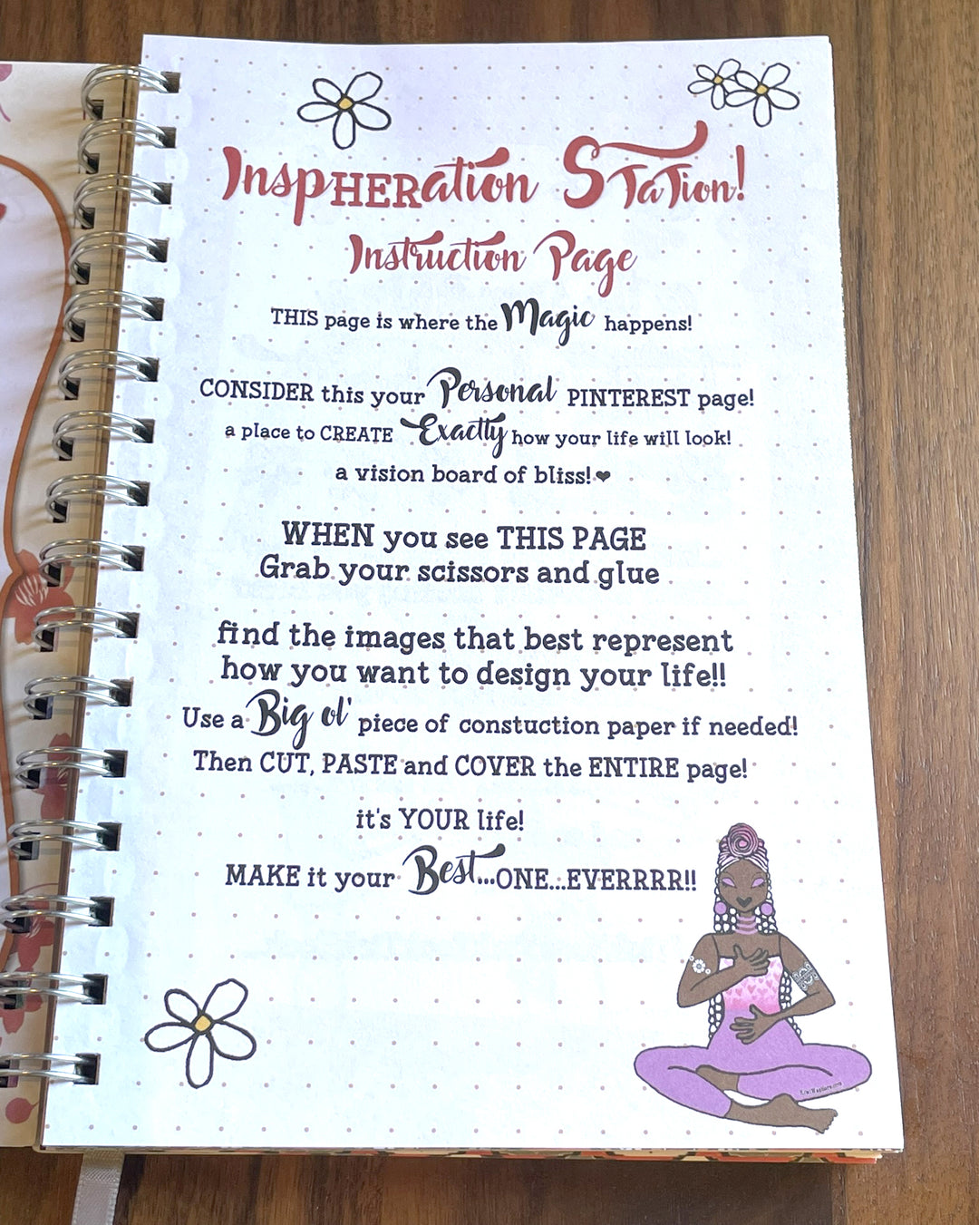 Good Vibes & Voice Mails 2027 Weekly Inspirational Planner by Kiwi McDowell (Affirmations Pages) - An open spiral-bound notebook showing a printed instruction page titled 'Inspiration Station! Instruction Page' with decorative text, small flower illustrations, and a purple seated figure drawing on the lower right. The notebook lies on a wooden surface.