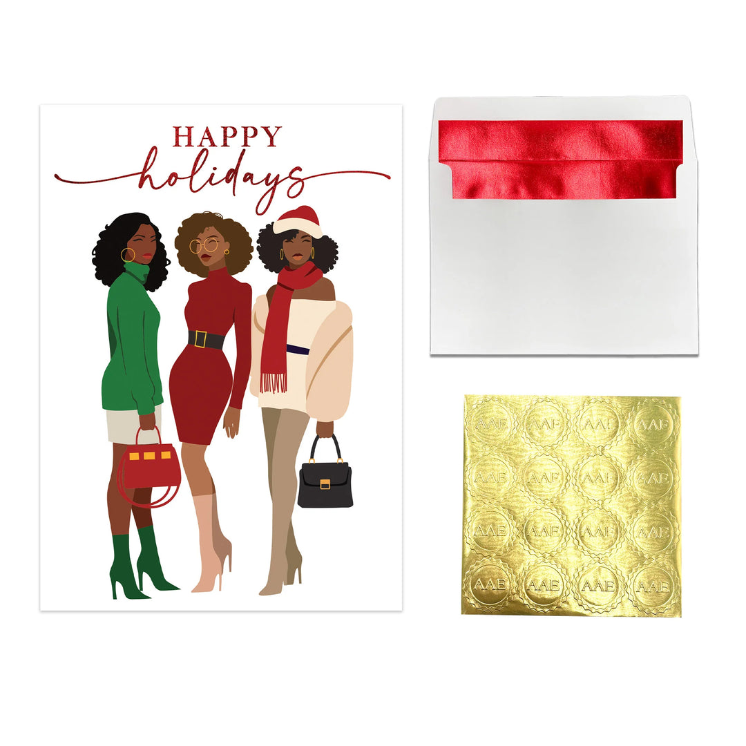 Happy Holidays: African American Christmas Card Box Set (Full Product View) - Holiday card with three women, a red envelope, and gold foil sheet on a white background