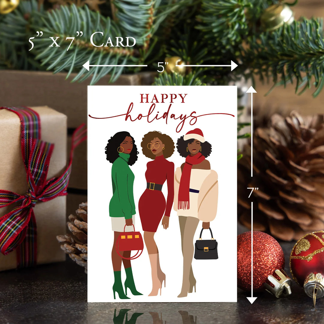 Happy Holidays: African American Christmas Card Box Set (Sizing Guide) - Holiday card with three illustrated women in festive attire, surrounded by Christmas decorations.