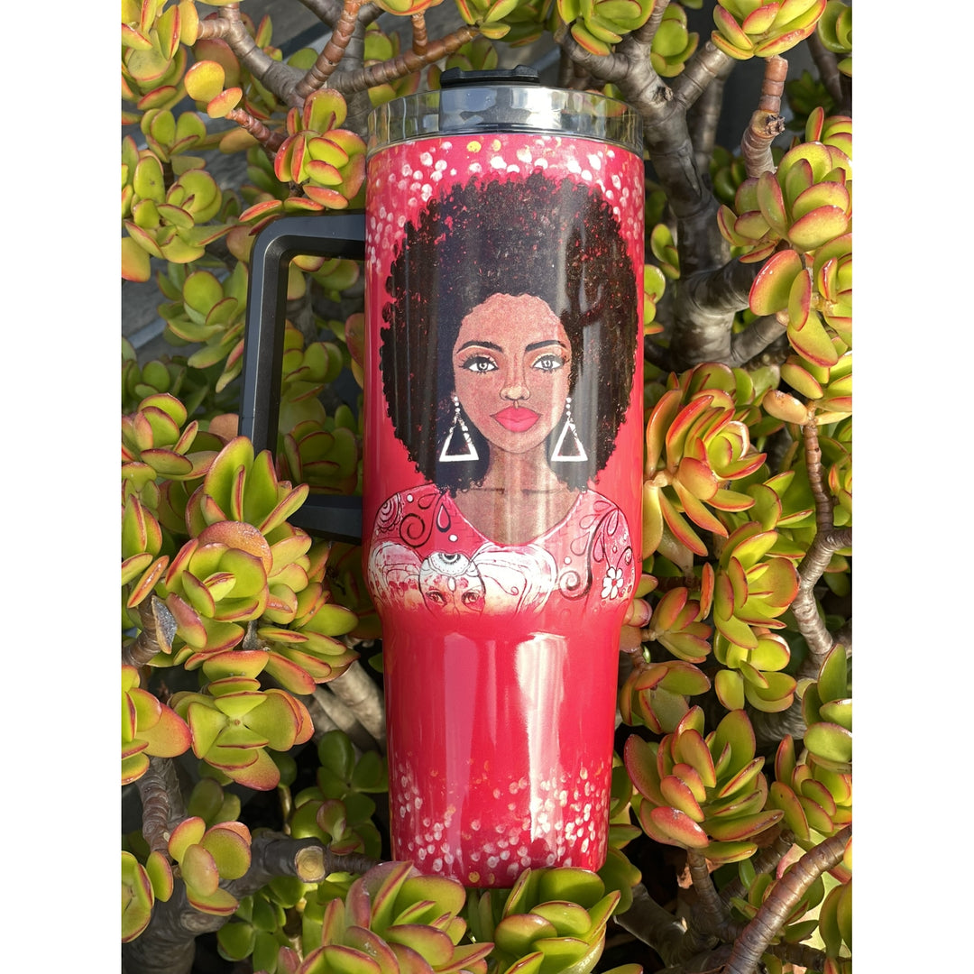 I am Powerful by Sylvia "GBaby" Cohen: Detla Sigma Theta Tumbler with Handle (Lifestyle) - A red insulated tumbler with a black handle and lid, featuring a printed illustration of a woman with an afro and geometric earrings, set against a background of green succulent plants.