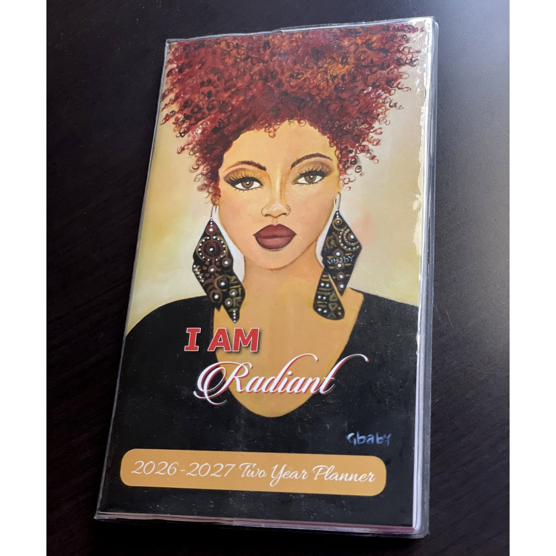 I Am Radiant by Sylvia "Gbaby" Cohen: 2026-2027 Two Year African American Pocket Planner (Lifestyle Photo) - Planner with a woman's face and 'I AM Radiant' text on a dark surface