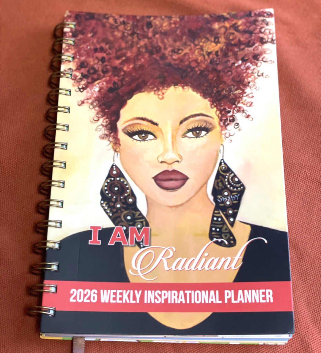 I Am Radiant by Syliva "Gbaby" Cohen: 2026 African American Weekly Inspirational Planner (Lifestyle Front 2) - Planner with a cover featuring an illustration of a woman with text 'I AM Radiant' on a brown background