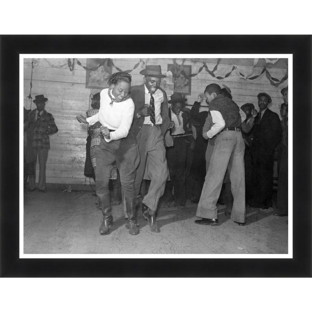 Jitterbug Juke Joint 1939 by Marion Post Wolcott (Black Frame) - Two men dancing in a room with other people in the background, framed photo
