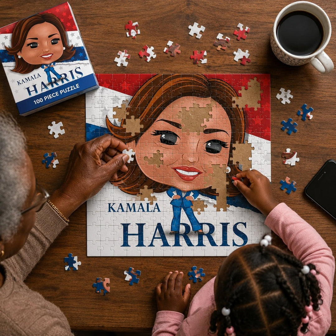 Kamala Harris 100-Piece Commemorative Jigsaw Puzzle (Lifestyle) - A top-down view of a wooden table with a partially assembled custom puzzle showing a cartoon portrait of Kamala Harris. Two people are visible from the shoulders up, placing puzzle pieces around the artwork.