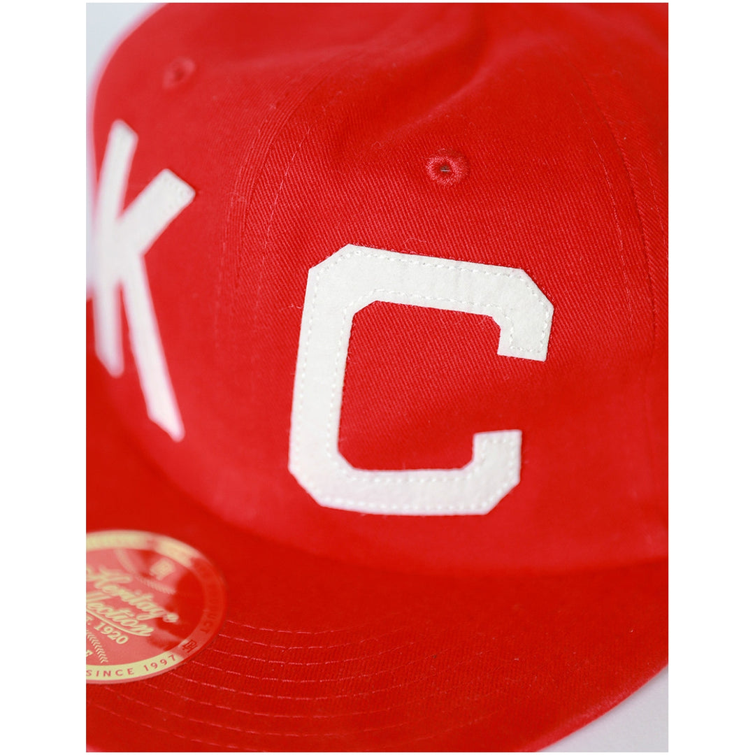 Kansas City Monarchs Heritage Cotton Snapback Baseball Cap (Front Detail) - Red cap with white letter 'C' and 'K' on a white background