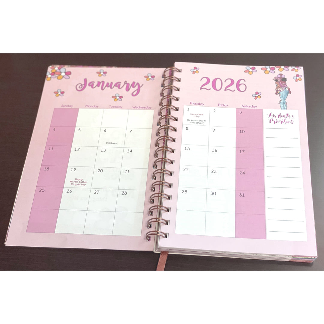 Blessed Sista Energy by Kiwi McDowell: 2026 Weekly Inspirational Planner (Monthly View) - Open spiral-bound planner showing January 2026 on a pink cover with floral designs.