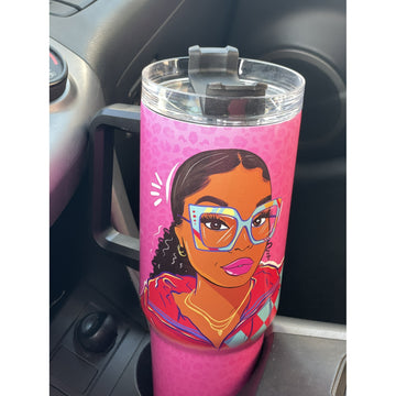 Live Life in Color by Madeleine Wood: African American Tumbler with Handle (Lifestyle) - A pink insulated tumbler with a clear lid and handle, featuring a cartoon illustration of a woman with glasses, placed in a car cup holder.
