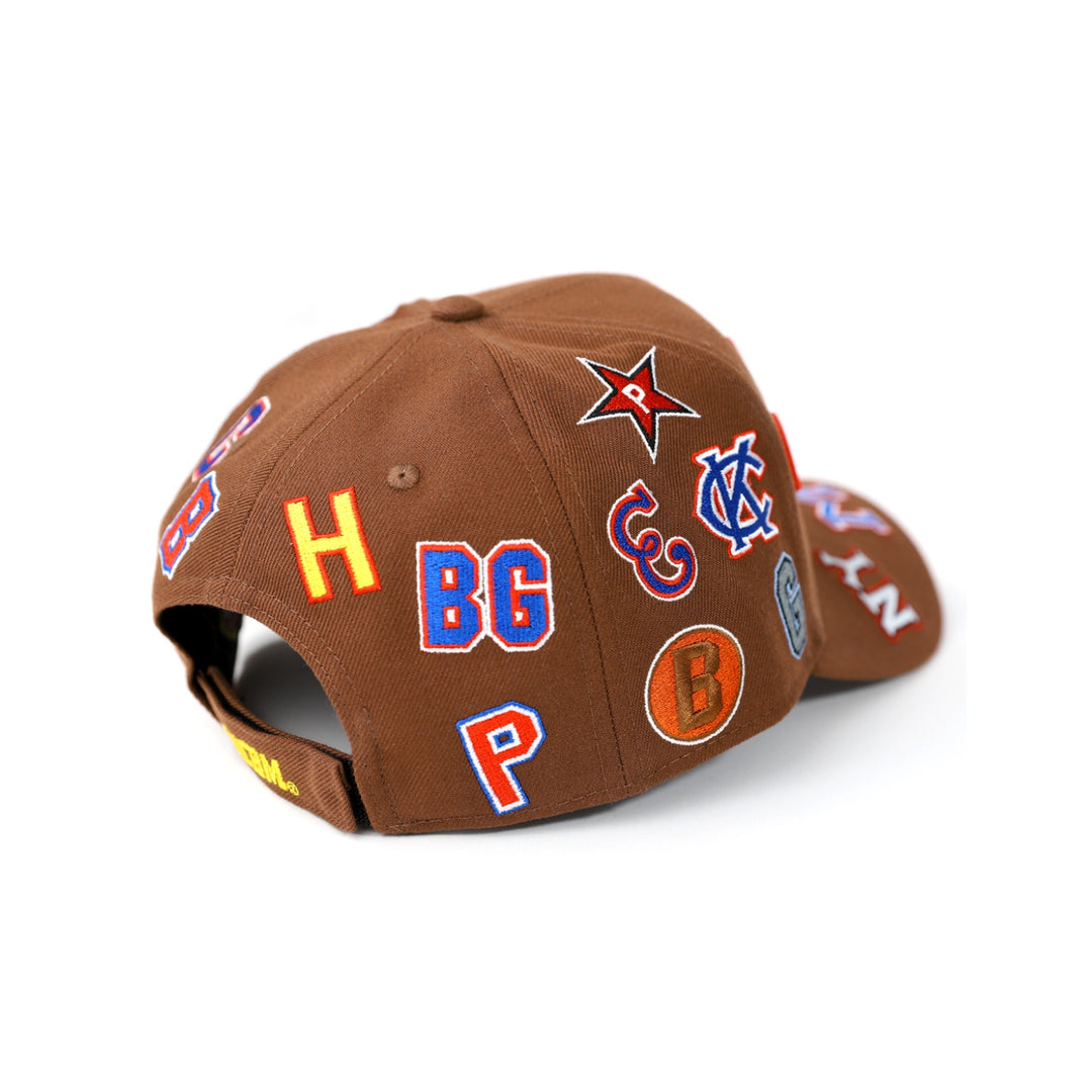 Negro League Commemorative Baseball Cap (Rear 2, Brown) - Brown cap with various colorful logos and letters on a white background