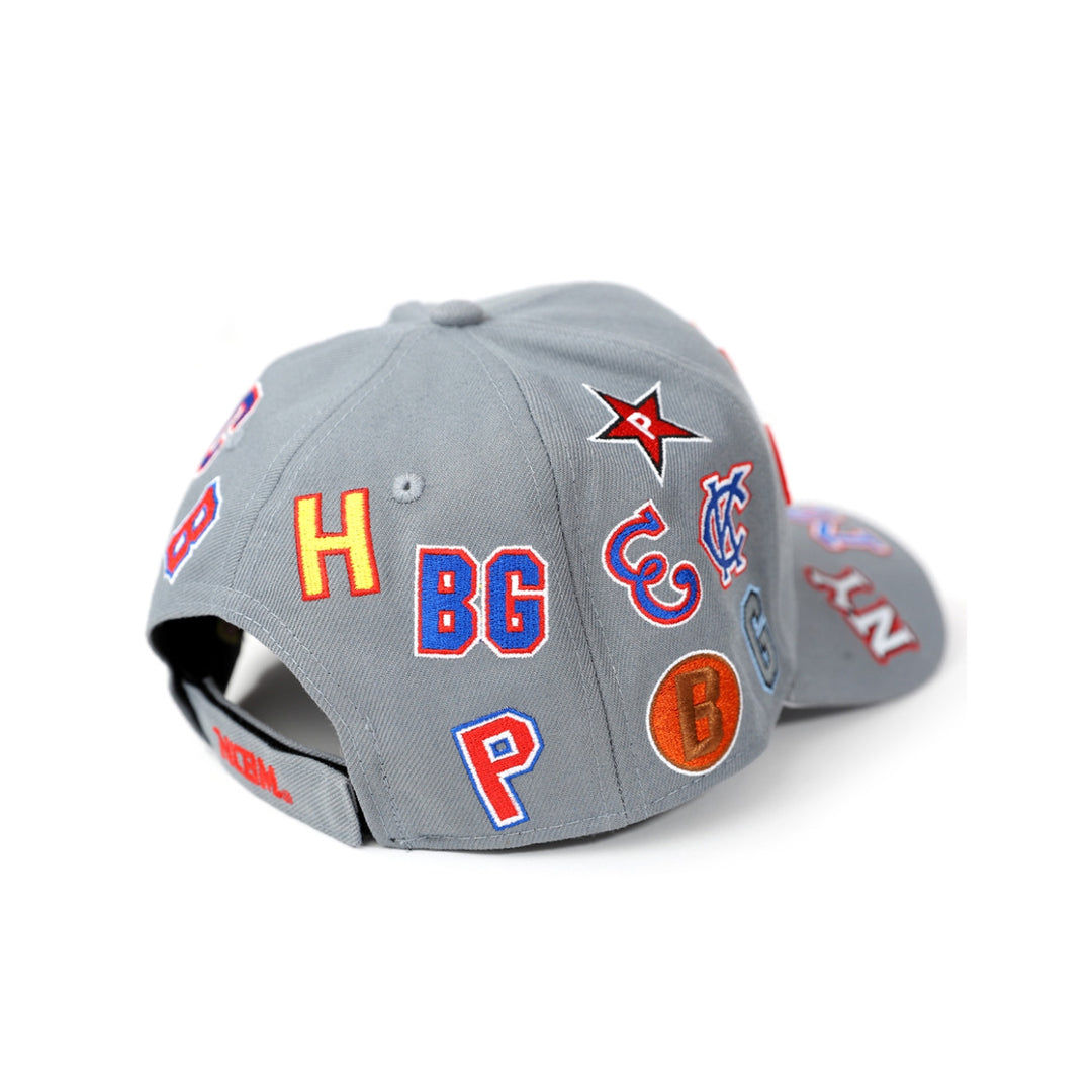 Negro League Commemorative Baseball Cap (Rear 2, Gray) - Gray cap with various colorful logos and letters on a white background
