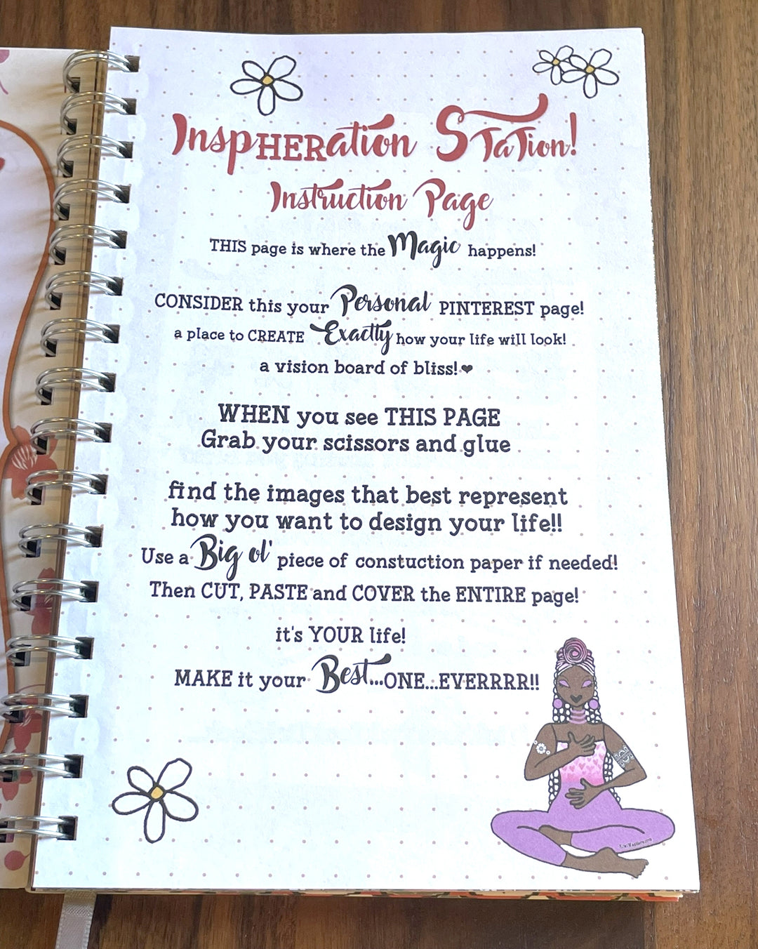 Net Worth and Nature Trails 2027 Weekly Inspirational Planner by Kiwi McDowell (Inspheration Station II) - An open spiral-bound notebook showing a printed instruction page titled 'Inspiration Station! Instruction Page' with decorative text, small flower illustrations, and a purple seated figure drawing on the lower right. The notebook lies on a wooden surface.