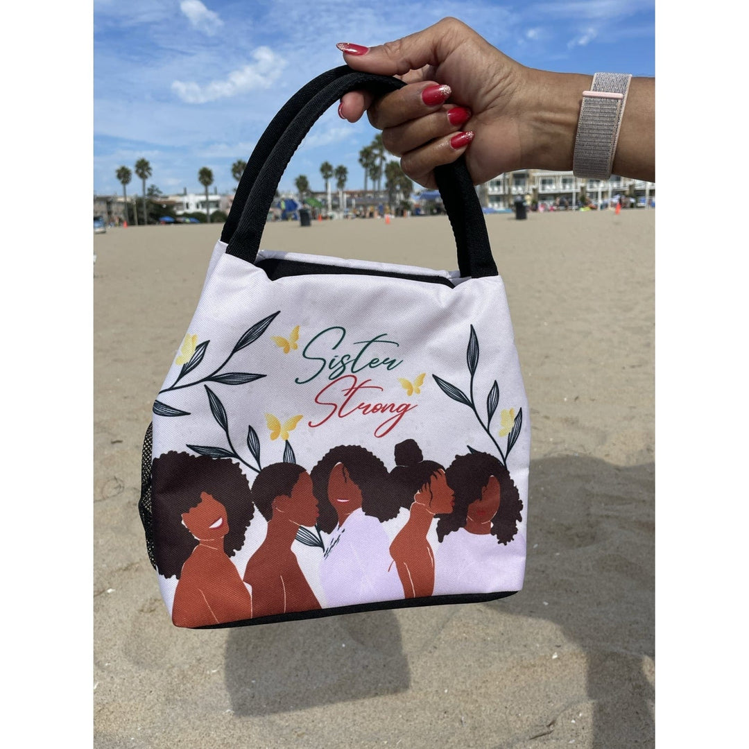 Janine Kai Robinson's Sister Strong lunch bag featuring Black women silhouettes (lifestyle 2)
