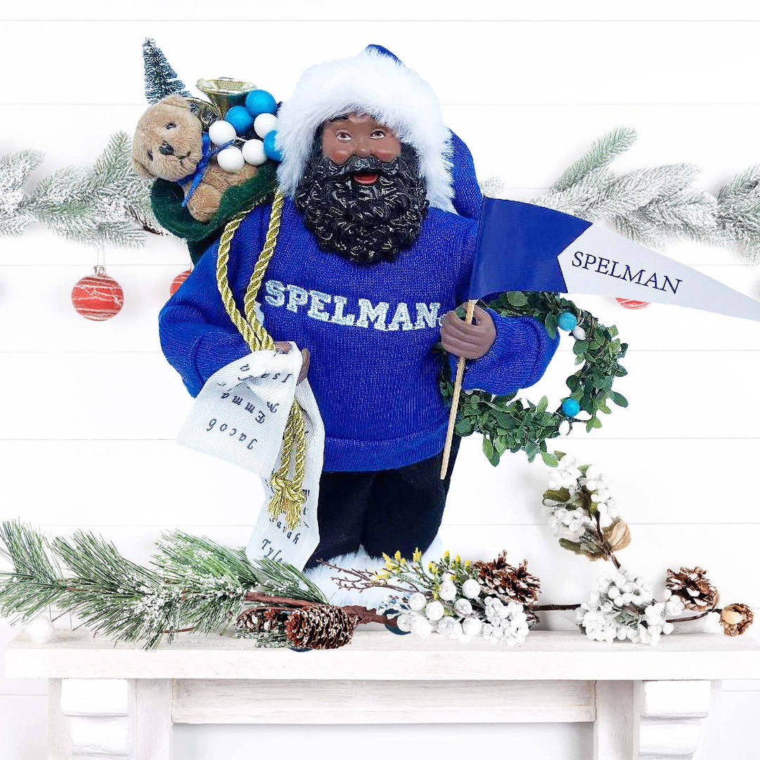 Spelman Santa Claus figurine on a white holiday mantel with winter garland