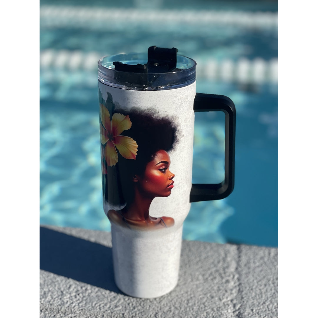 Strong and Special: African American Religious/Faith Tumbler with Handle (Lifestyle) - A white insulated travel tumbler with a black handle and lid, featuring a printed graphic of a woman with an afro and a yellow flower, set against a blurred swimming pool background.