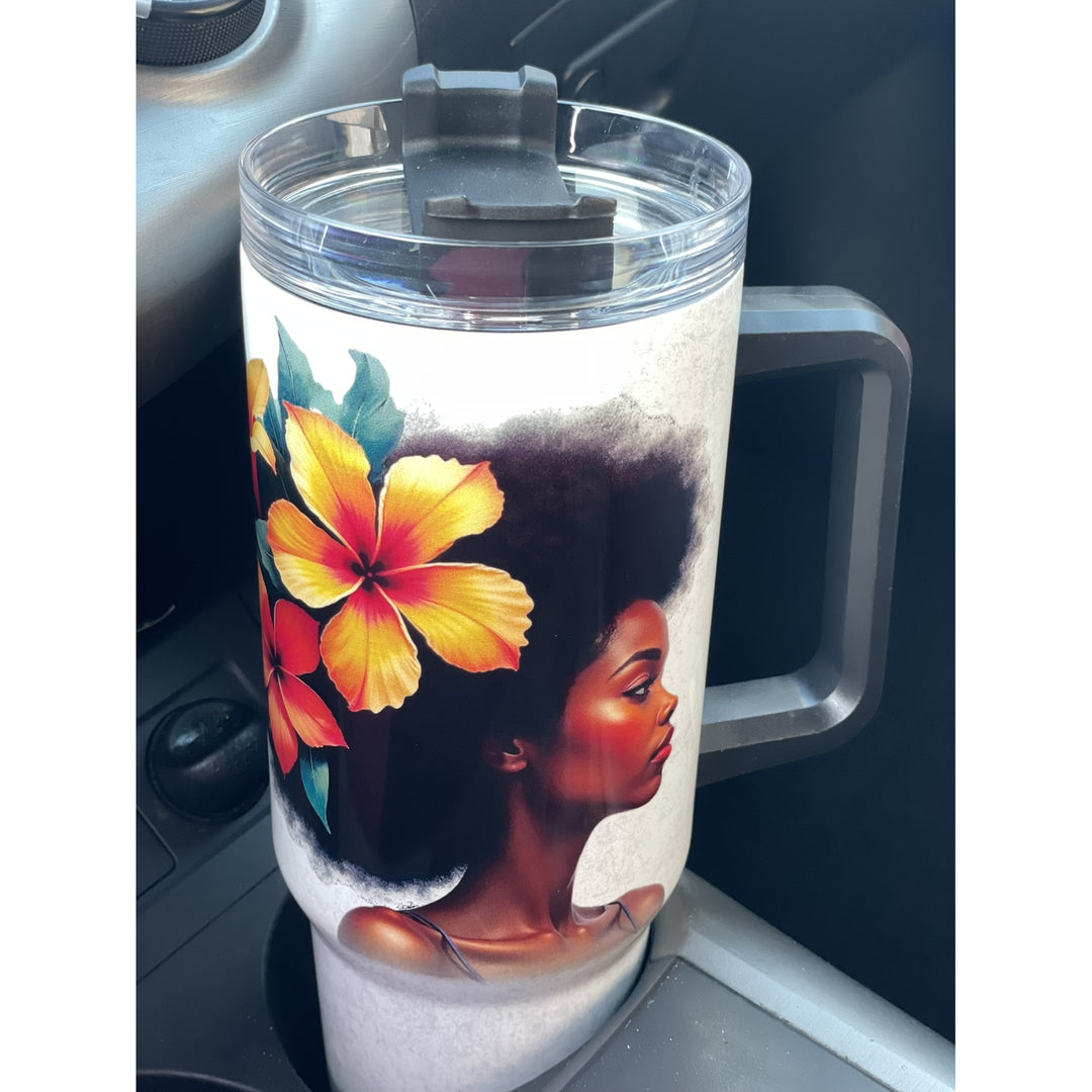 Strong and Special: African American Religious/Faith Tumbler with Handle (Lifestyle) - A handled insulated tumbler with a clear lid and black flip-straw cover, featuring a printed design of a Black woman in profile with a large yellow and orange hibiscus flower on a white background, photographed inside a car cup holder.