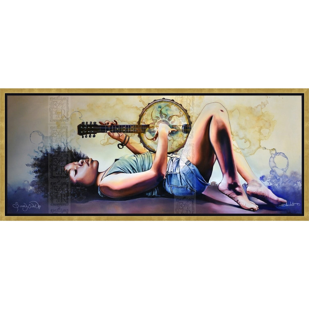 Sunny Side Up by Edwin Lester (Canvas, Gold Floater Frame) - A framed horizontal canvas print featuring a stylized painting of a woman lying down with her legs bent, holding a guitar and a tambourine. The artwork has a gold-toned frame and is presented against a plain white background.